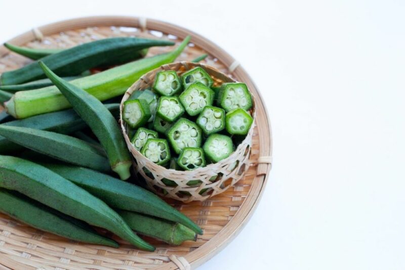 Oh, Green Eggs and OKRA!, image of Okra in a bowl on a wooden plate.