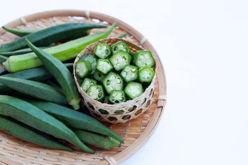 Oh, Green Eggs and OKRA!, image of Okra in a bowl on a wooden plate.