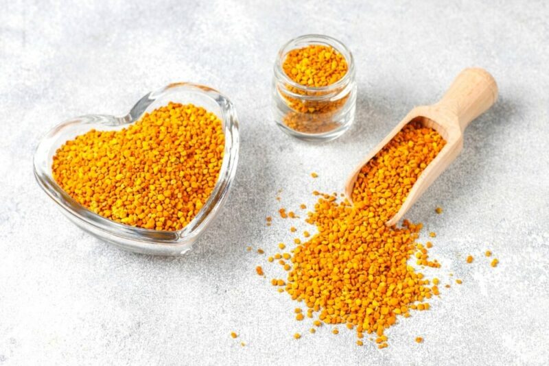Bee Pollen- Nature's Superfood, image of bee pollen on a table with a glass heart shaped container