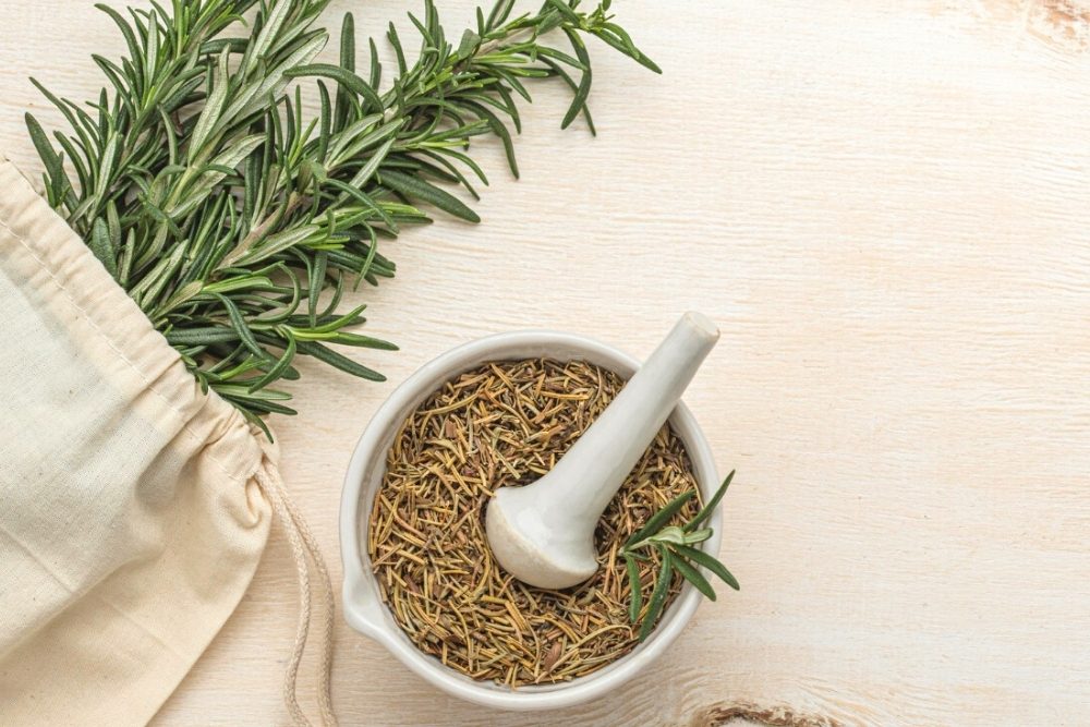 Medicinal and Practical Uses for Rosemary, image of rosemary in a mortar.