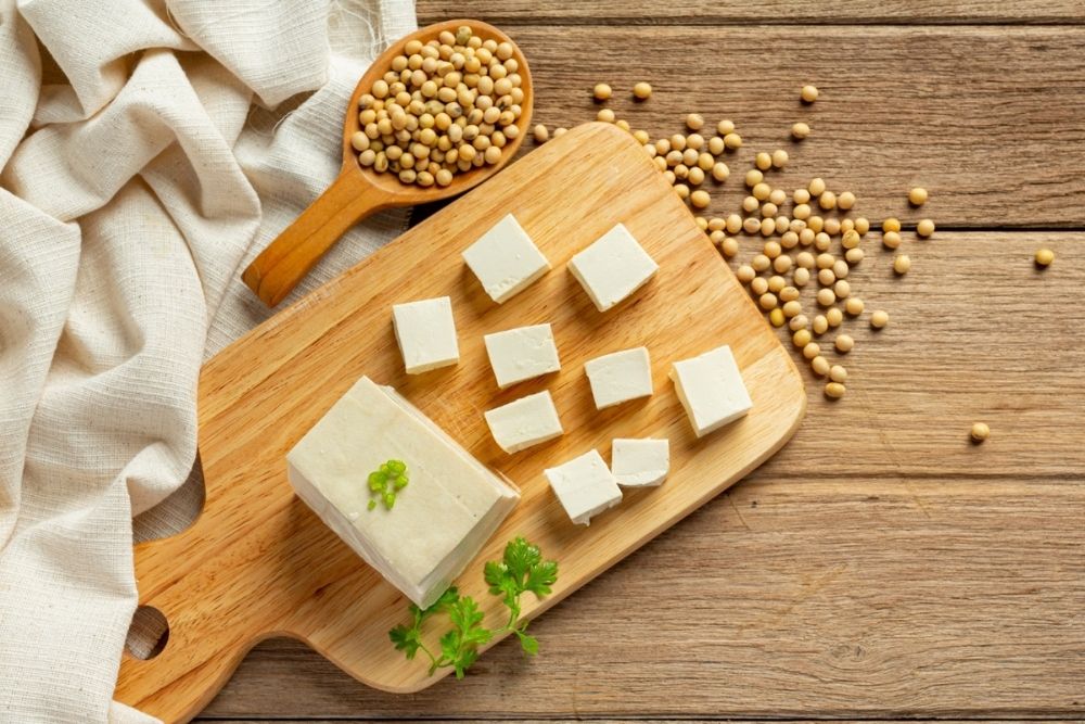 Surprising Ways to Make Tofu Flavorful and Reap the Health Benefits image of tofu on a cutting board