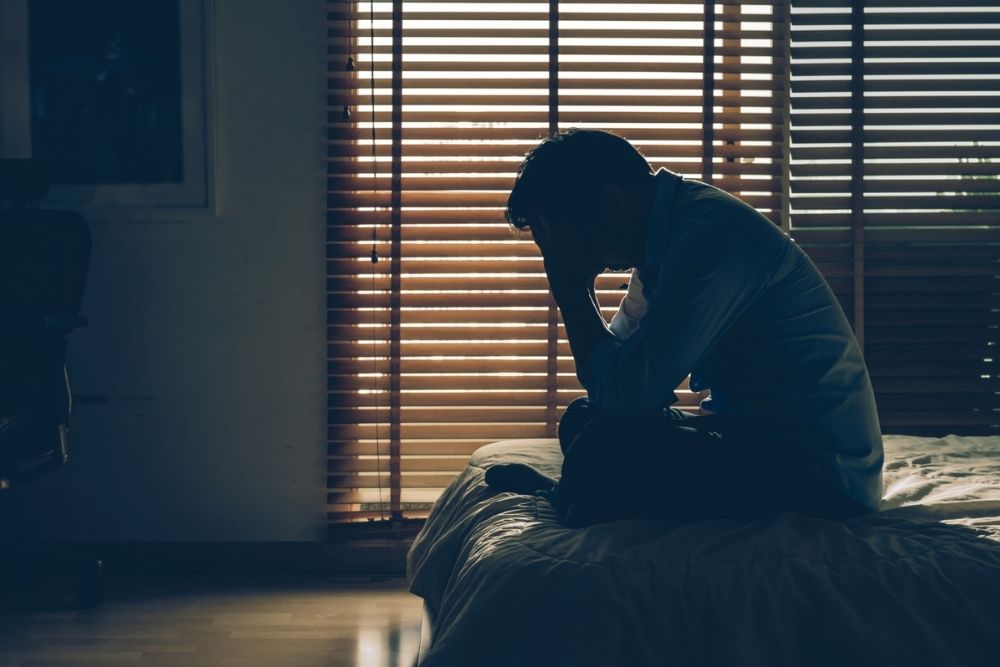 Understanding Pyrrole Disorder, image of a man depressed at the edge of a bed